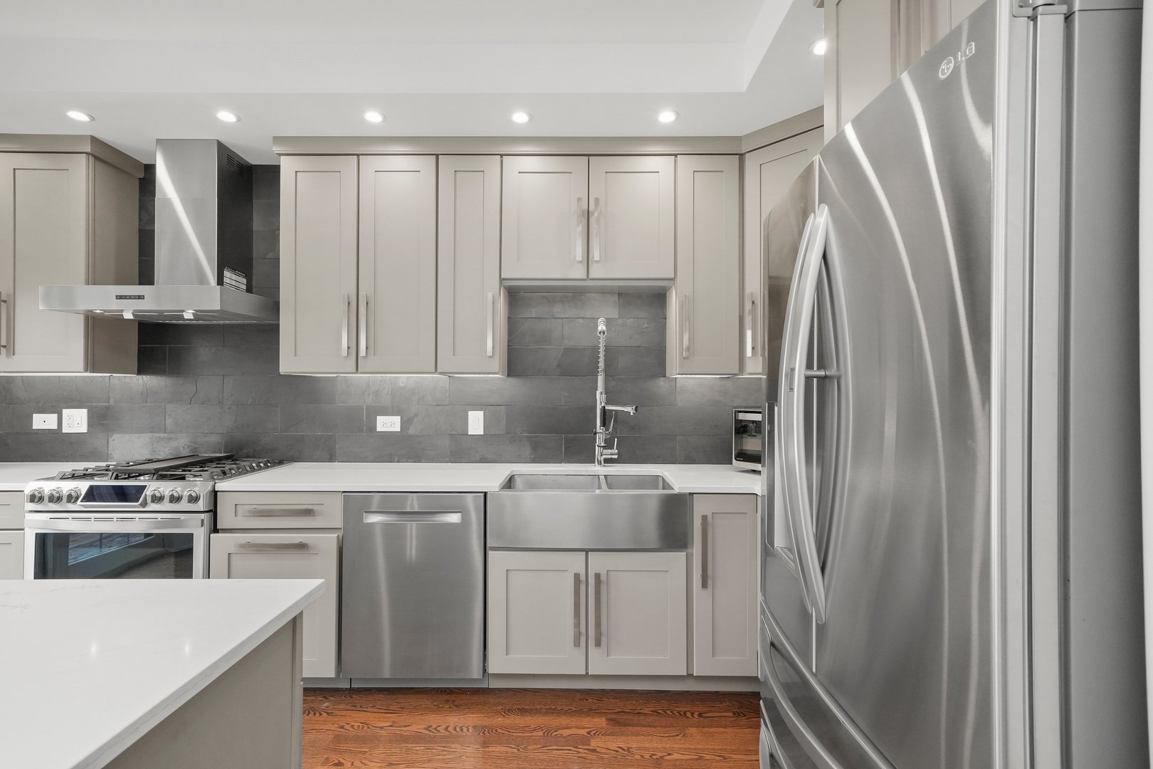 1026 West Monroe Street Chicago, IL 60607 - Photo 9 of 30 a kitchen with a white cabinets stove and refrigerator