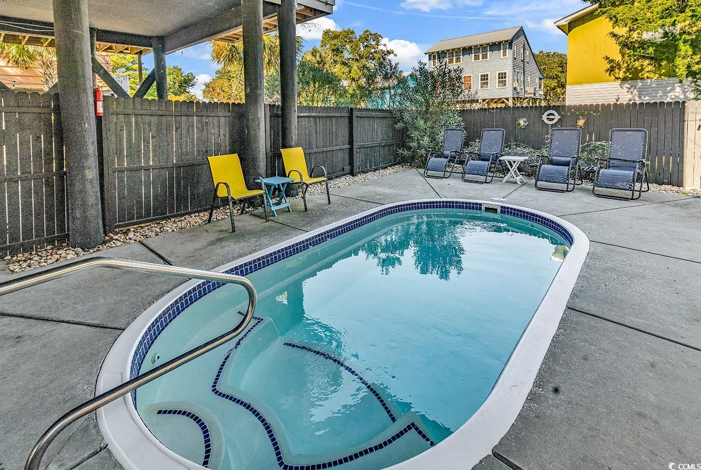 124 B Vista Drive Murrells Inlet, SC 29576 - Photo 33 of 38 View of swimming pool featuring a patio and a fenced backyard