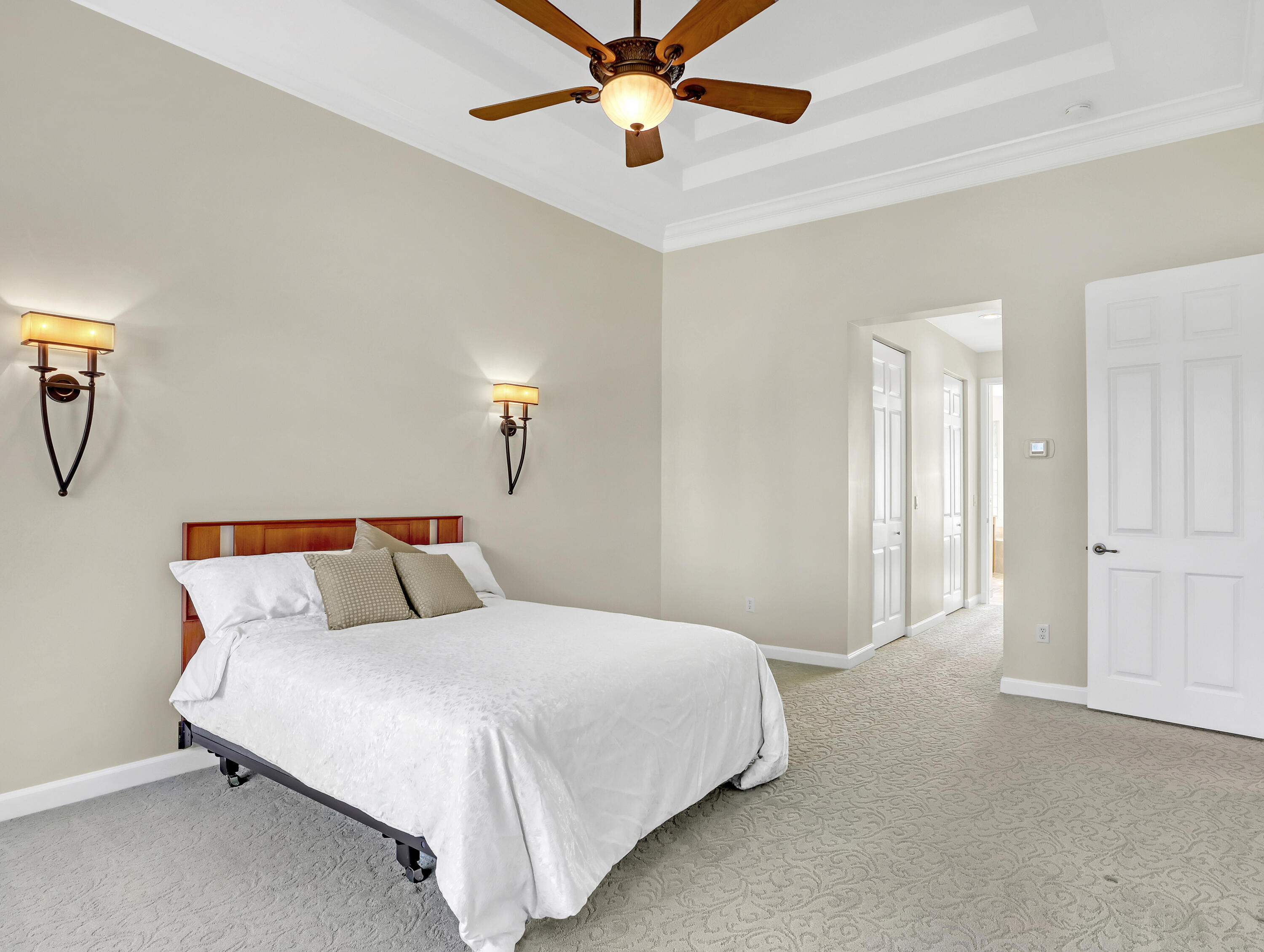 819 Southwest Bromelia Terrace Stuart, FL 34997 - Photo 20 of 48 a bedroom with bed and a chandelier