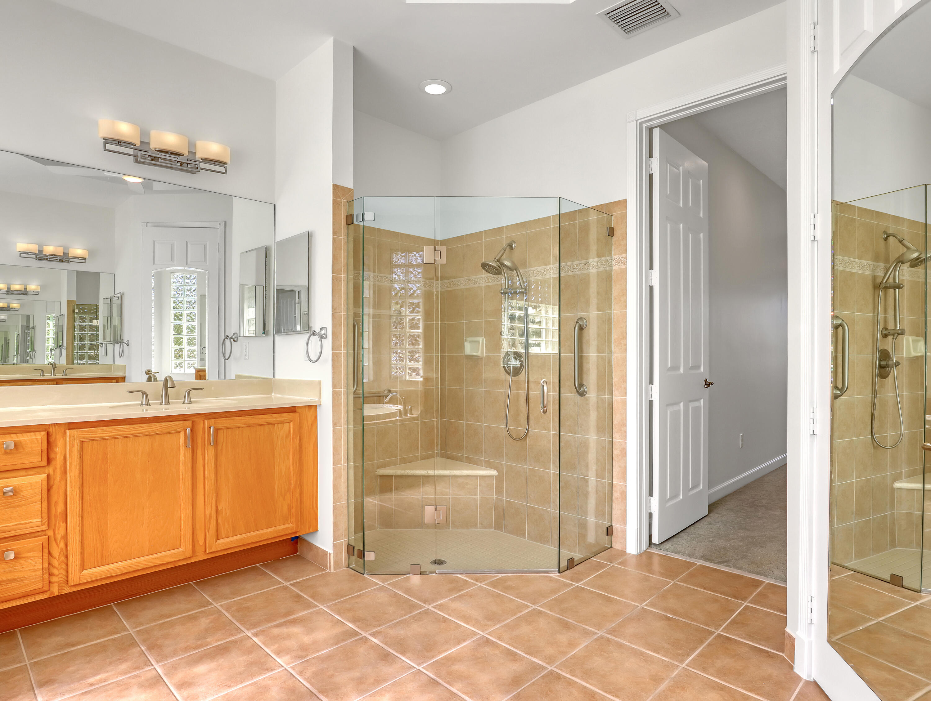 819 Southwest Bromelia Terrace Stuart, FL 34997 - Photo 23 of 48 a bathroom with a glass shower door and a sink