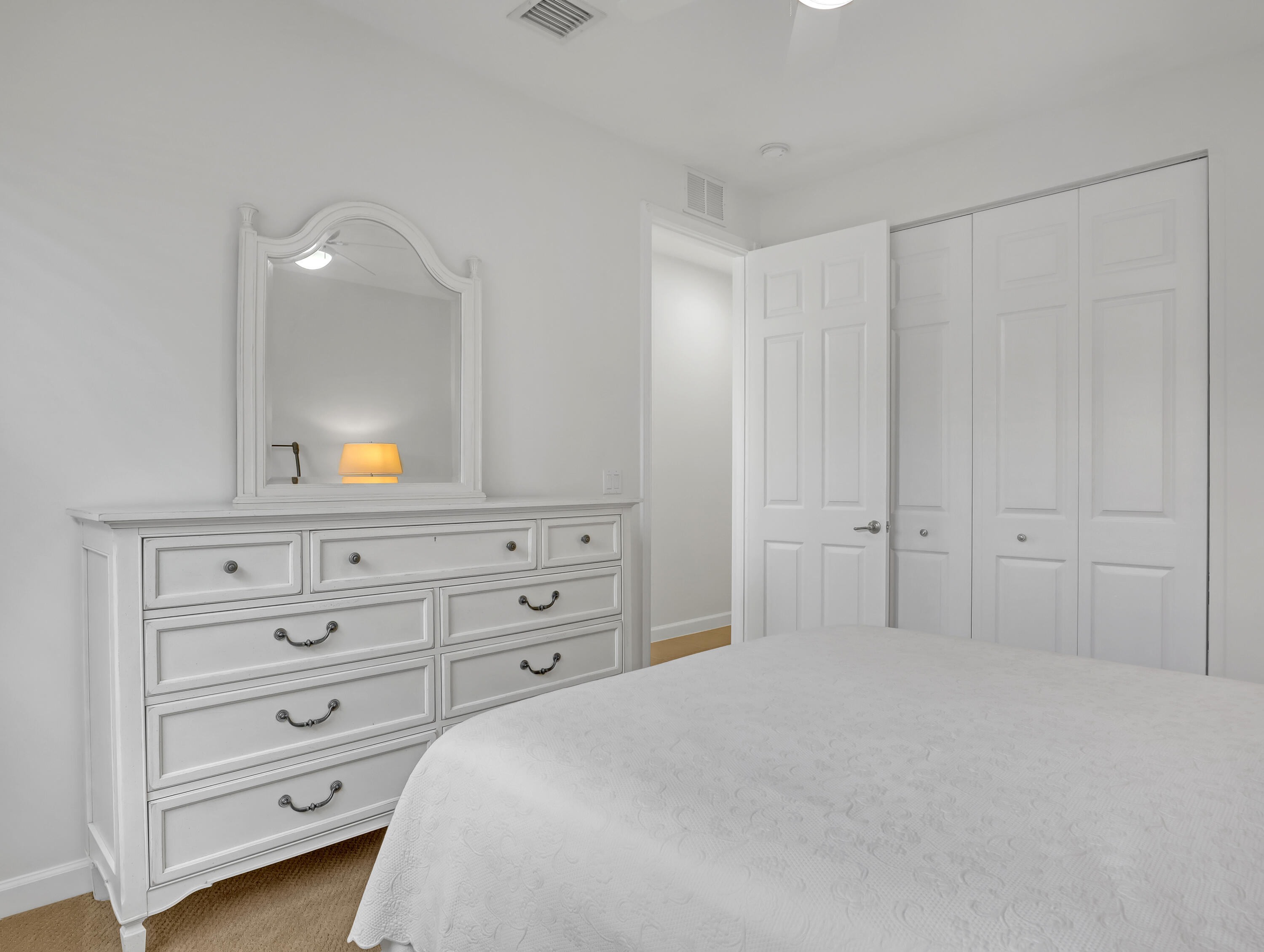 819 Southwest Bromelia Terrace Stuart, FL 34997 - Photo 25 of 48 a bedroom with a bed and a dresser