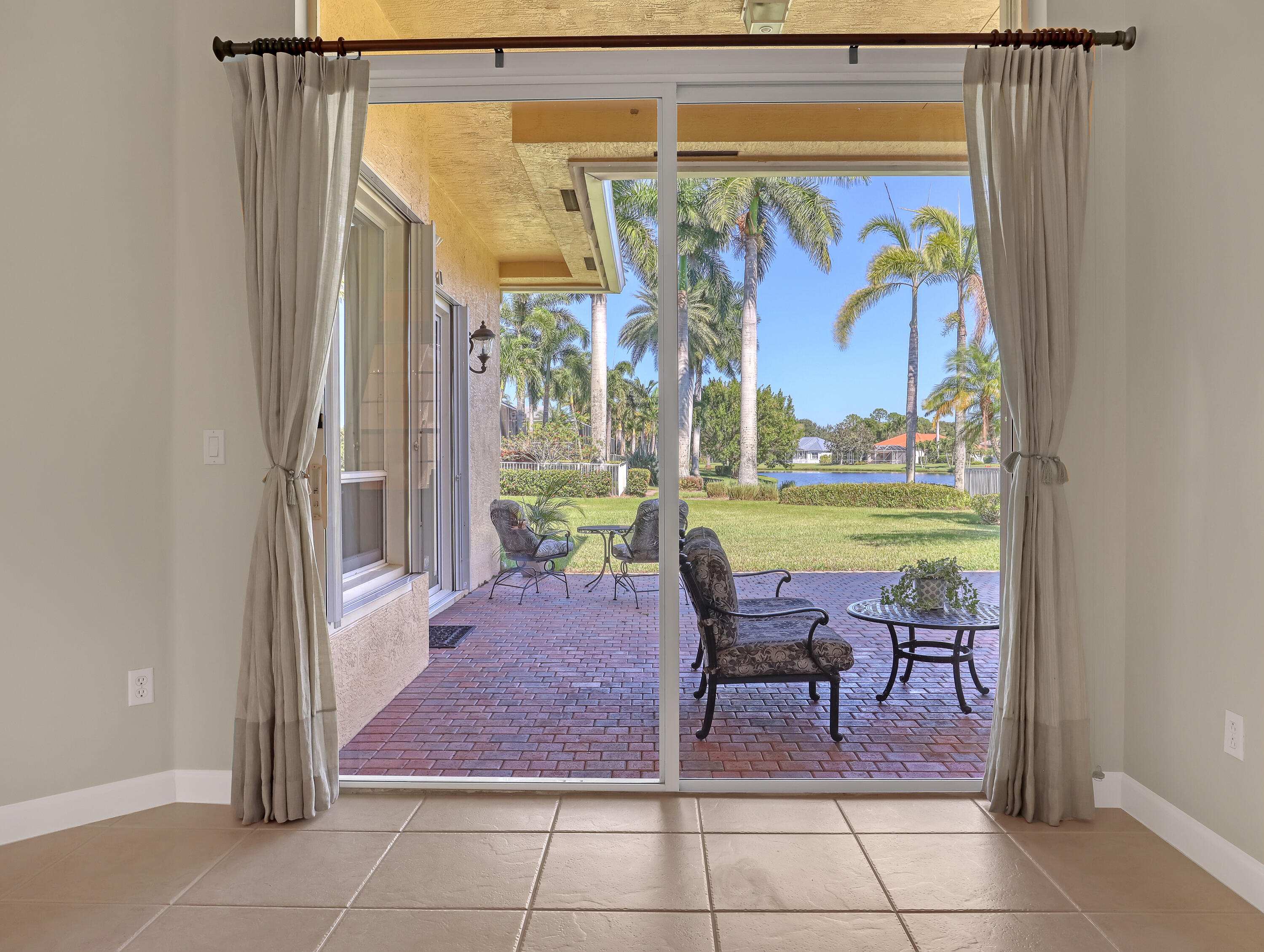 819 Southwest Bromelia Terrace Stuart, FL 34997 - Photo 4 of 48 a view of a chairs and table in a patio