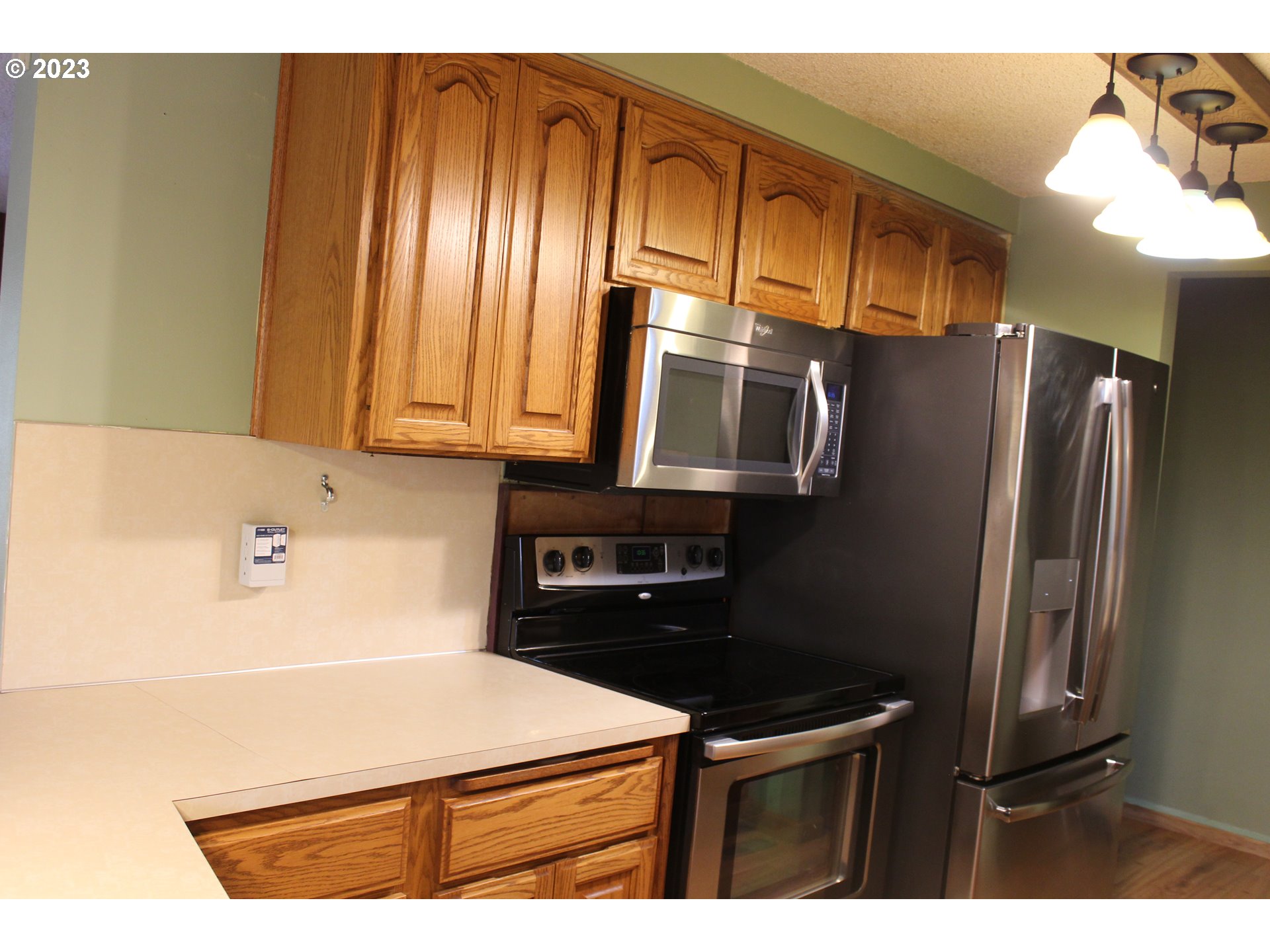 2355 11th Street Springfield, OR 97477 - Photo 8 of 16 a kitchen with stainless steel appliances a refrigerator and a stove