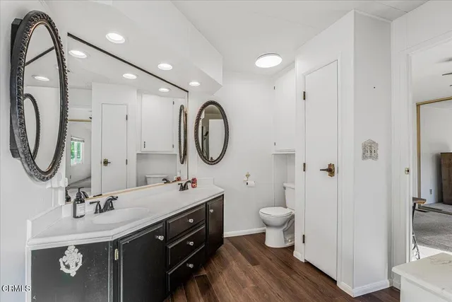 a bathroom with a toilet sink and mirror