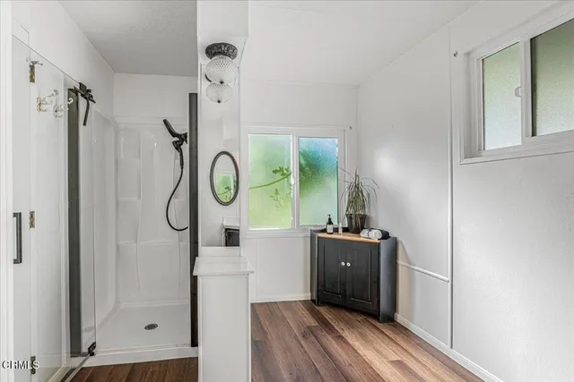 a picture of a room with wooden floor and white walls