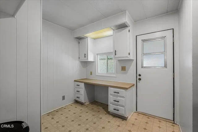 a kitchen with a sink a stove and cabinets