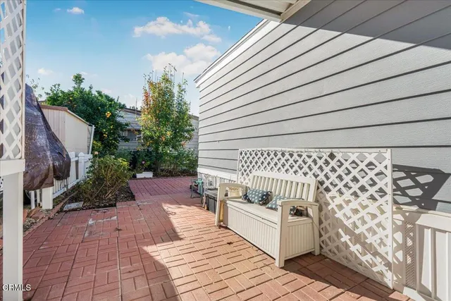 a view of a patio with table and chairs with wooden floor and fence