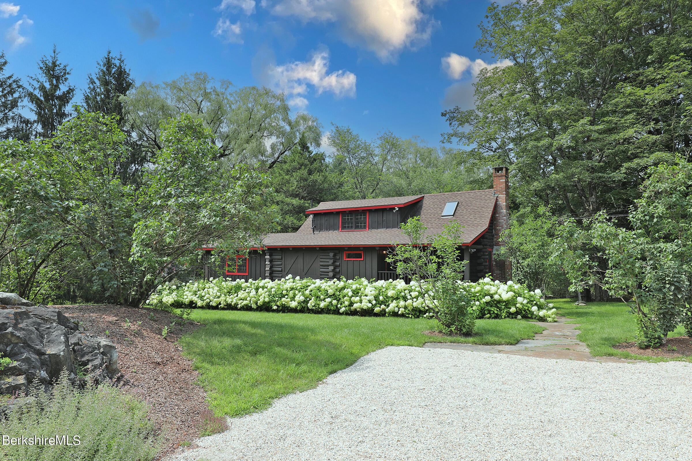 a view of a garden with a house in the background