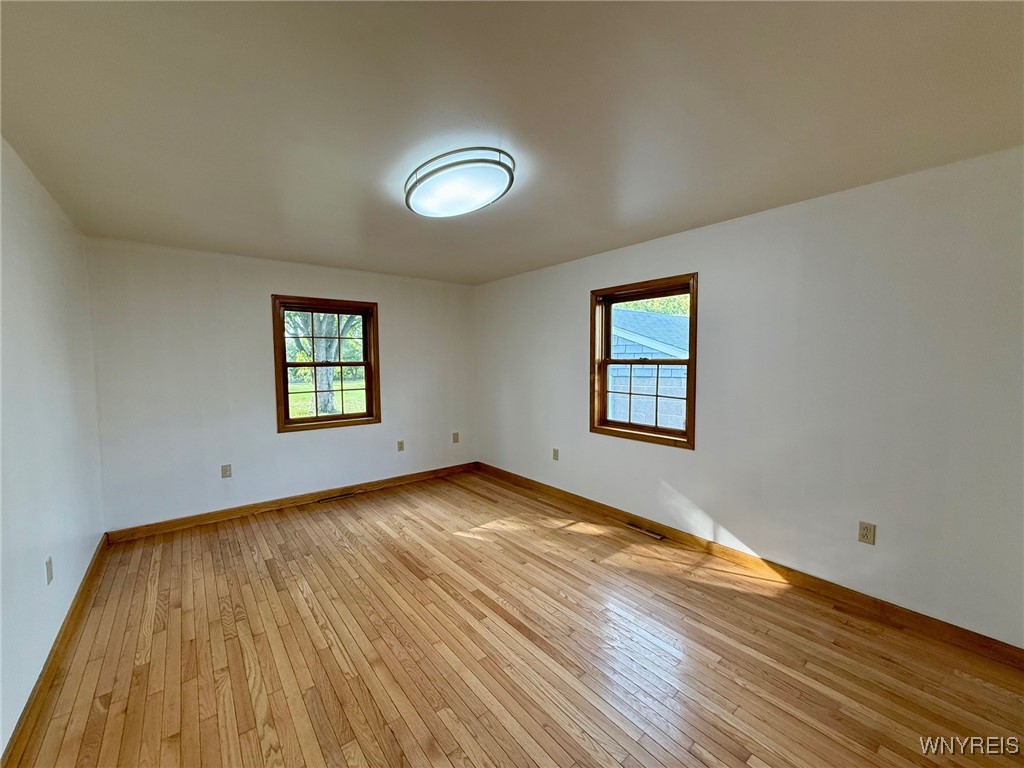 4628 Creek Rd Extension Lewiston, NY 14092 - Photo 27 of 39 Second bedroom with gleaming hardwood floors, whic