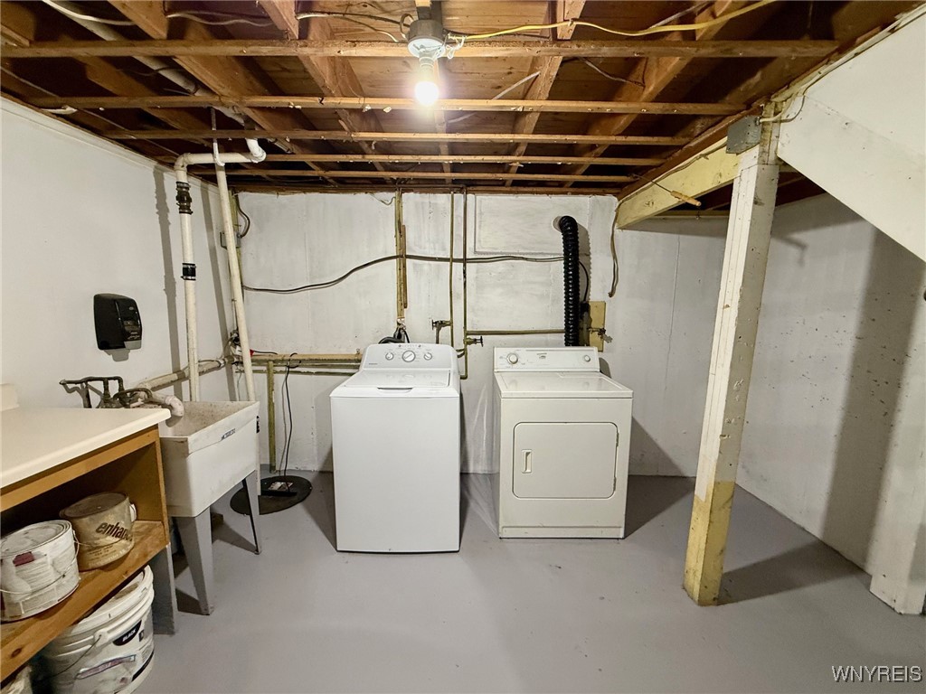 4628 Creek Rd Extension Lewiston, NY 14092 - Photo 37 of 39 Laundry area with shelving and a sump pump.