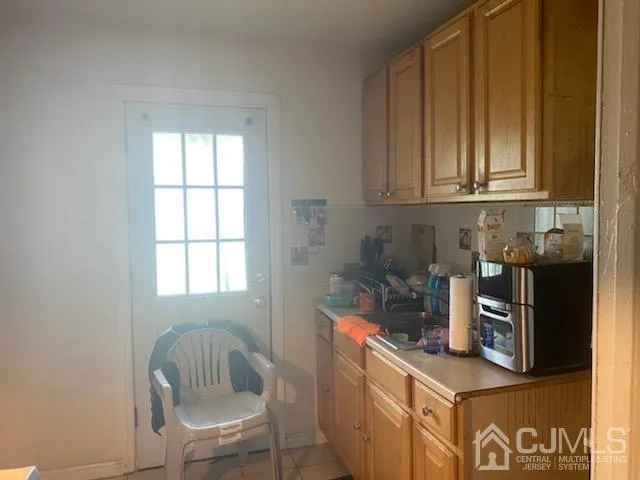 a kitchen with a window and cabinets