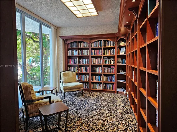 a living room with furniture and a book shelf