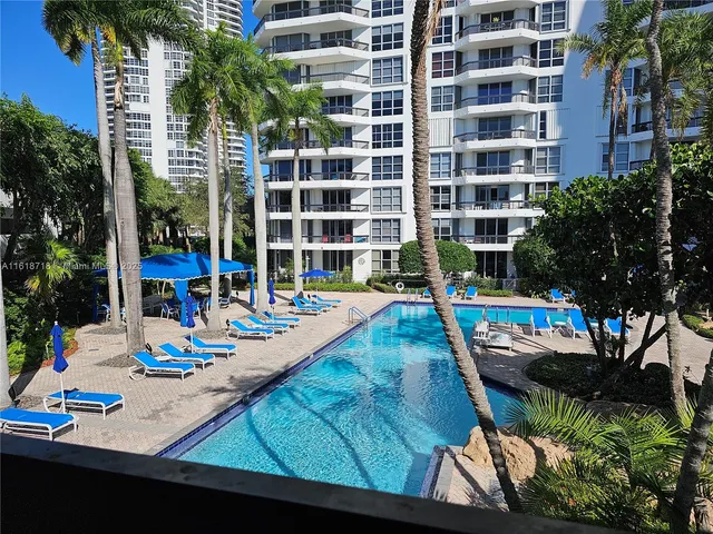 a view of a swimming pool with chairs