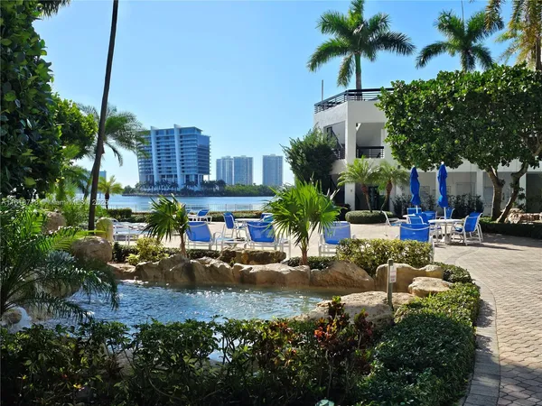 a view of multiple houses with palm trees