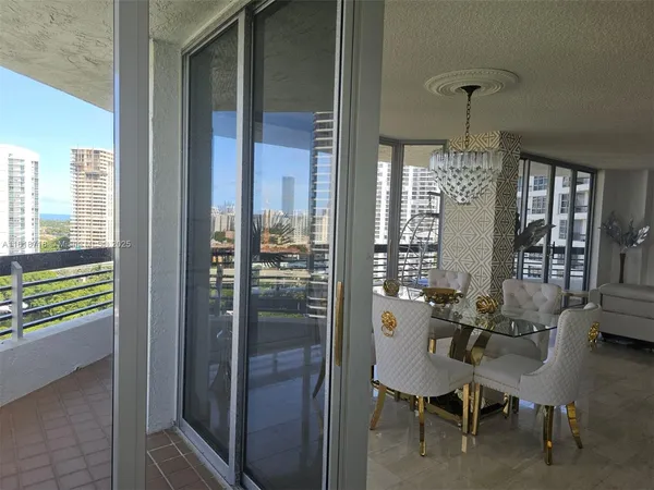 a view of a balcony dining table and chairs