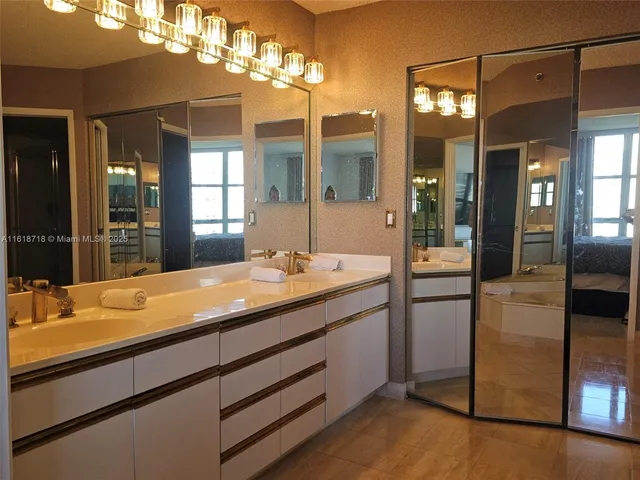 a bathroom with a shower sink and mirror