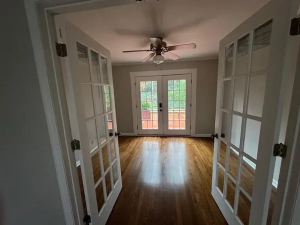 wooden floor in an empty room with a window