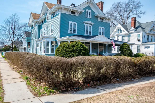 a front view of a house with a garden