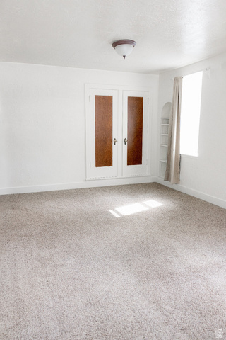 69 South Main Street Manti, UT 84642 - Photo 32 of 44 Bright interior space featuring light-toned carpeting and white painted walls