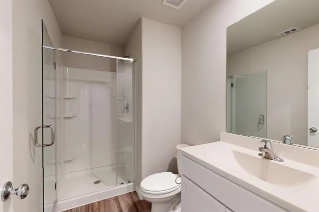 a bathroom with a sink toilet and shower