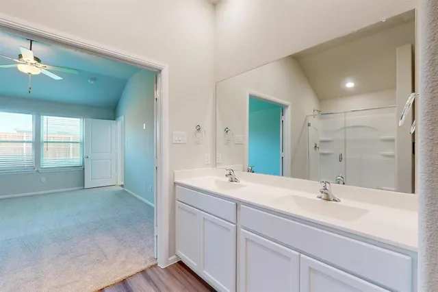 a bathroom with 2 sink and a mirror