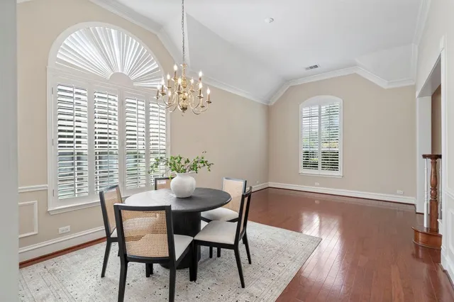 a view of a dining room with furniture and chandelier