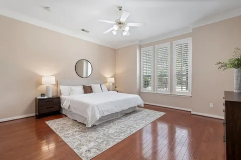 a bedroom with a large bed and a chandelier