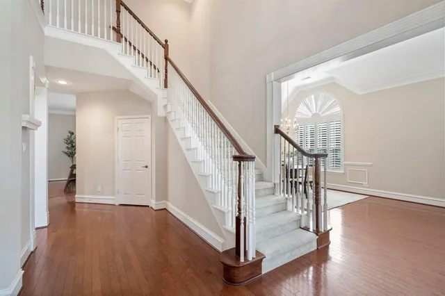 a view of entryway and hall with wooden floor