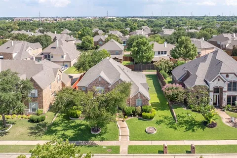 an aerial view of residential houses with outdoor space and street view
