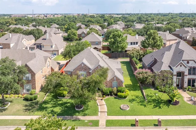 an aerial view of residential houses with outdoor space and street view