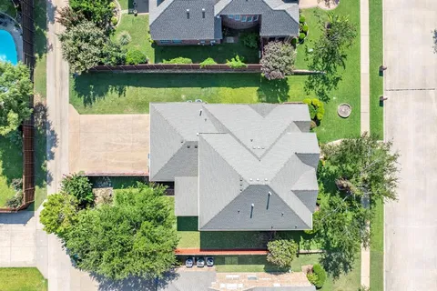 an aerial view of a house with a yard and a garden