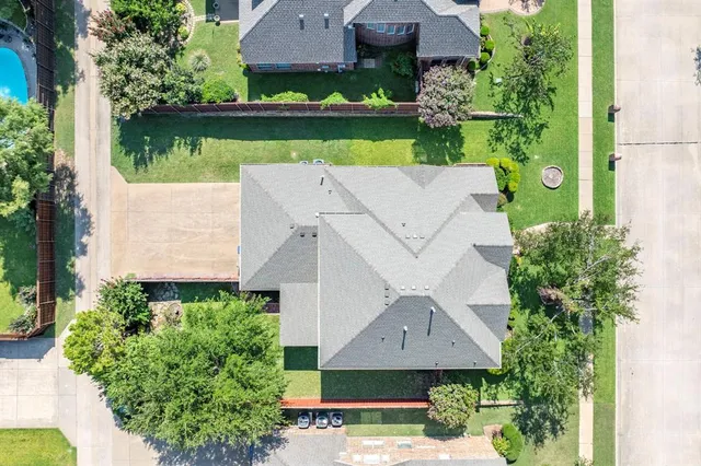 an aerial view of a house with a yard and a garden