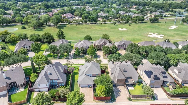 an aerial view of residential houses with outdoor space and lake view