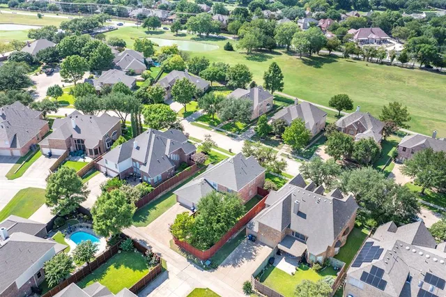 an aerial view of residential house with outdoor space and swimming pool