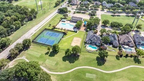 an aerial view of residential houses with outdoor space and swimming pool