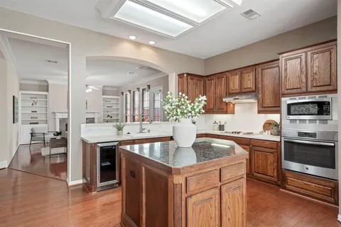 a kitchen with stainless steel appliances granite countertop a sink stove and cabinets
