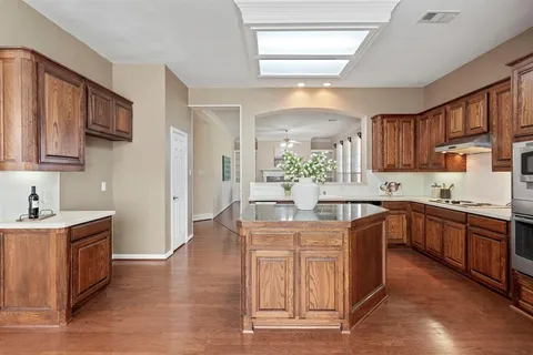 a kitchen with a sink cabinets and wooden floor