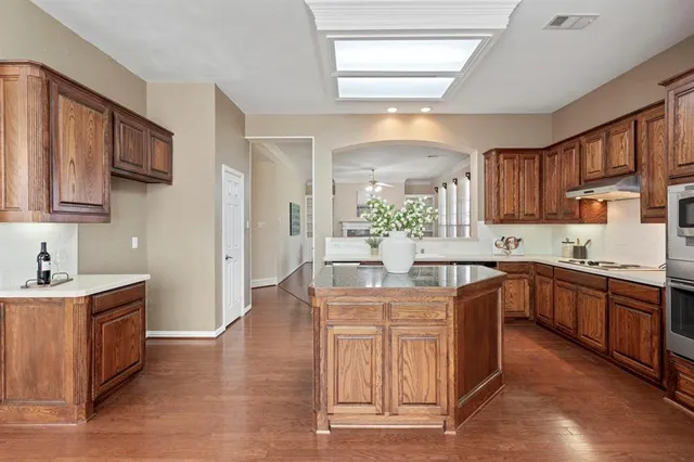 a kitchen with a sink cabinets and wooden floor