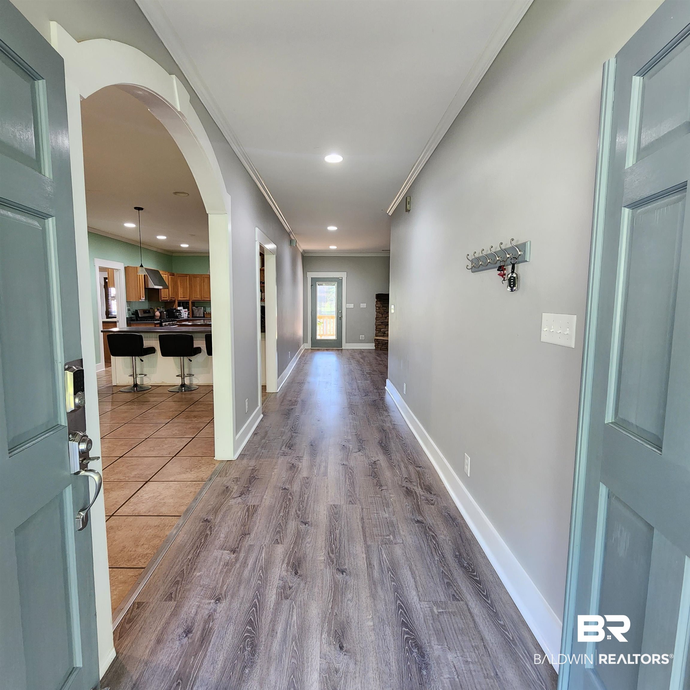 16093 Beasley Road Foley, AL 36535 - Photo 5 of 31 Corridor featuring wood-type flooring and crown molding