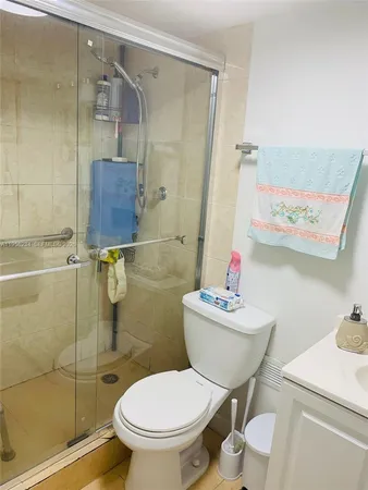 a white toilet sitting next to a bathroom sink