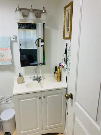 a bathroom with a sink toilet and mirror