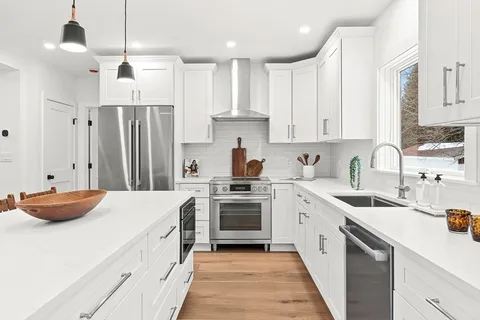a kitchen with stainless steel appliances a stove sink and cabinets
