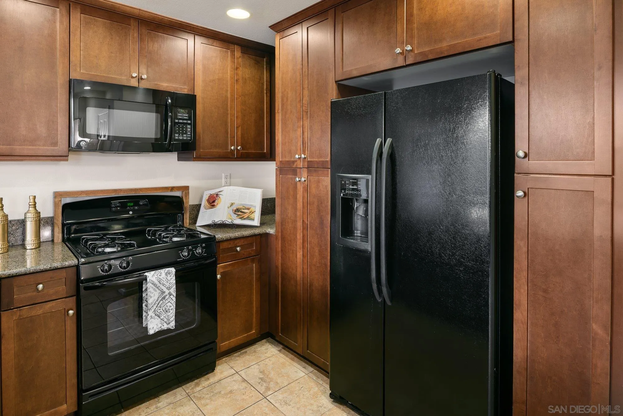 1402 Calabria Street Santee, CA 92071 - Photo 14 of 40 a kitchen with stainless steel appliances granite countertop a refrigerator stove and microwave