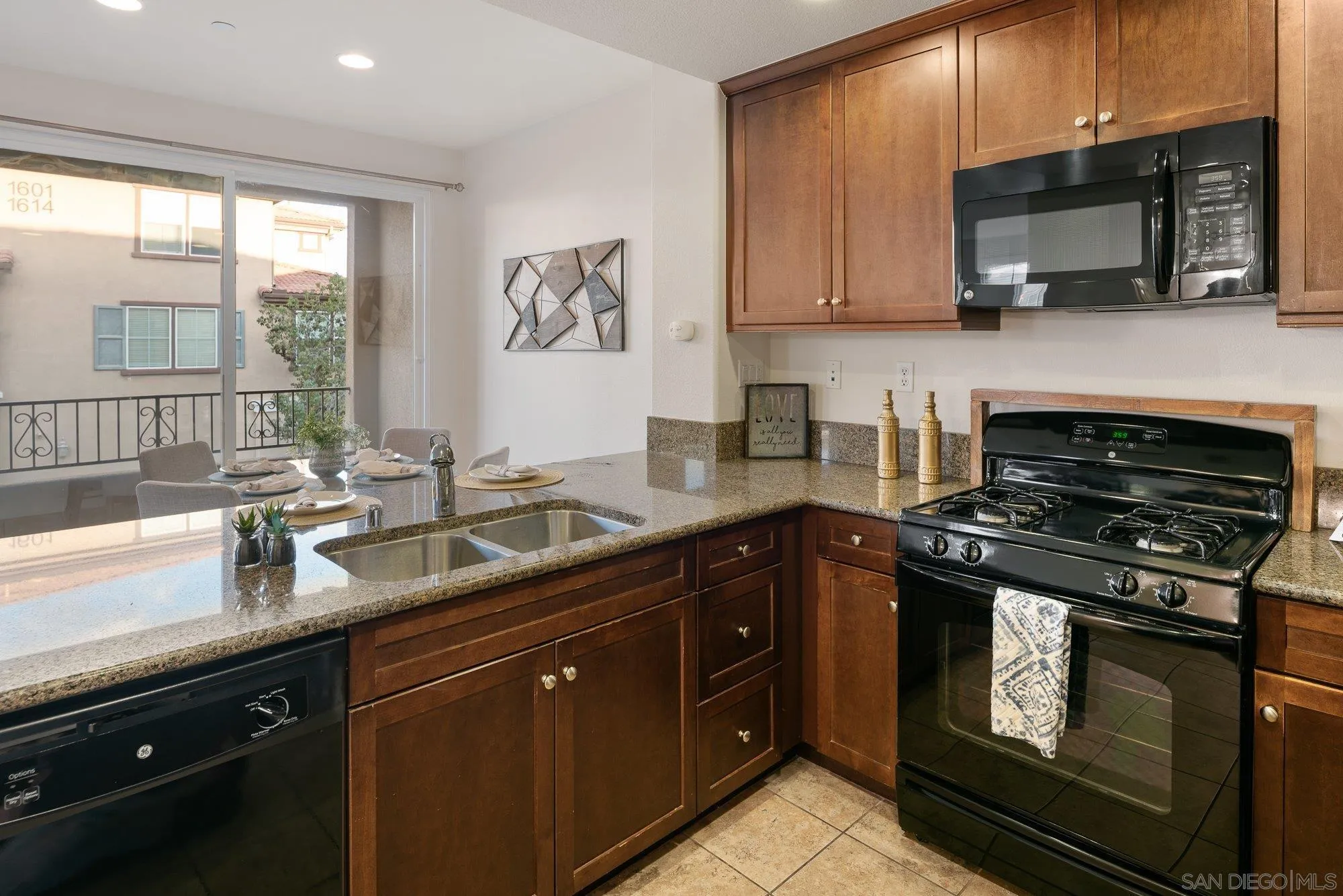 1402 Calabria Street Santee, CA 92071 - Photo 15 of 40 a kitchen with stainless steel appliances a stove sink microwave and window