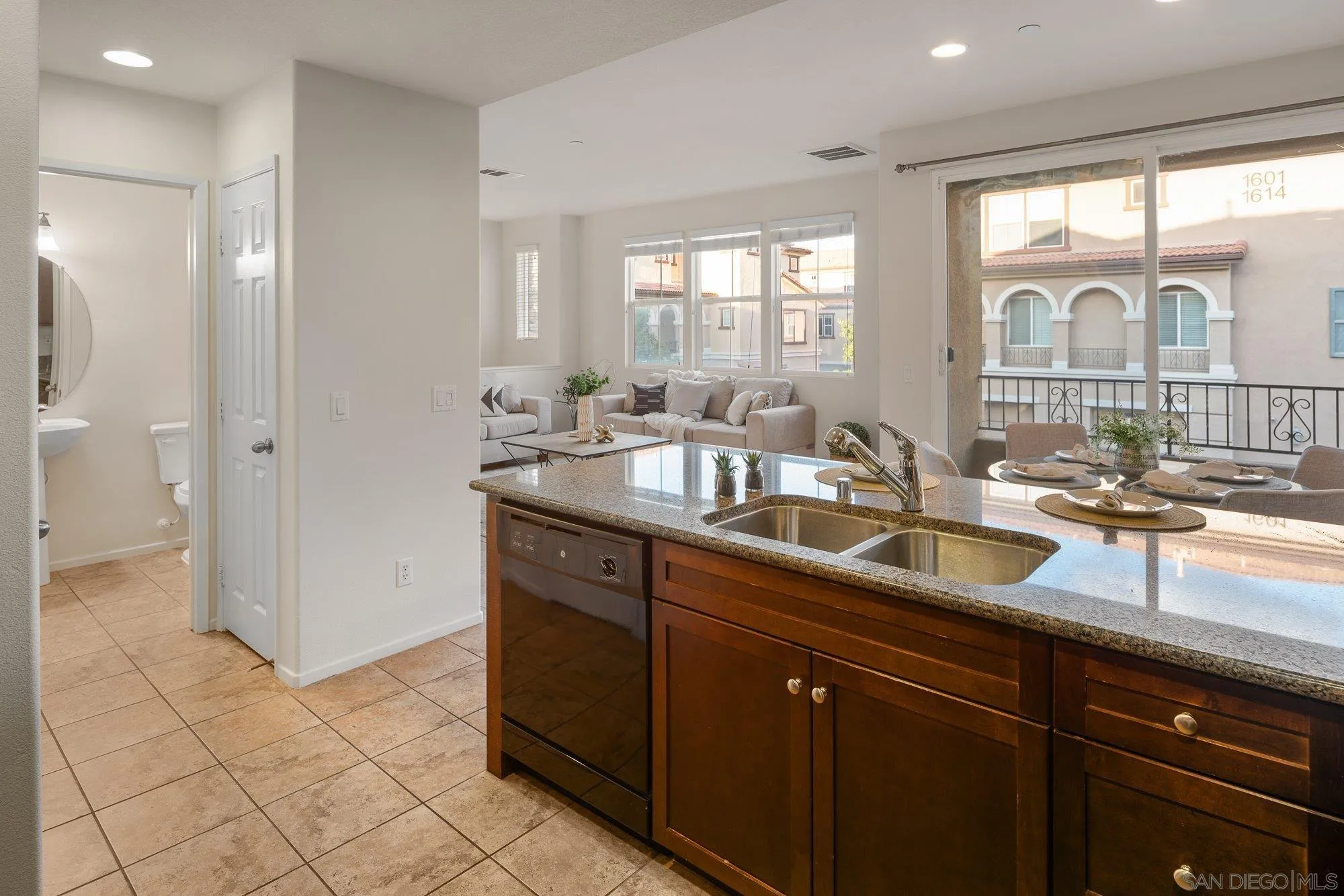 1402 Calabria Street Santee, CA 92071 - Photo 16 of 40 a kitchen with granite countertop a sink and a counter top space