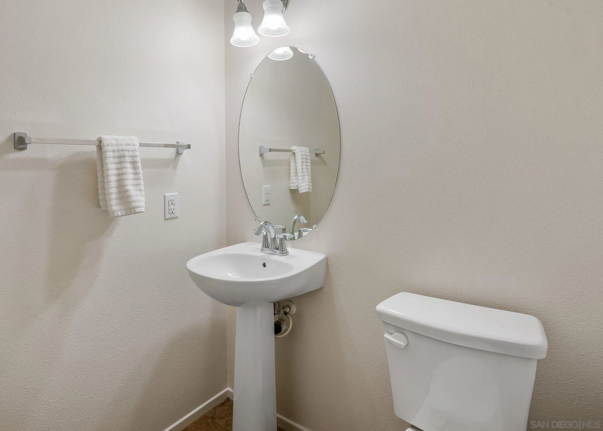 1402 Calabria Street Santee, CA 92071 - Photo 17 of 40 a bathroom with a toilet a sink and mirror