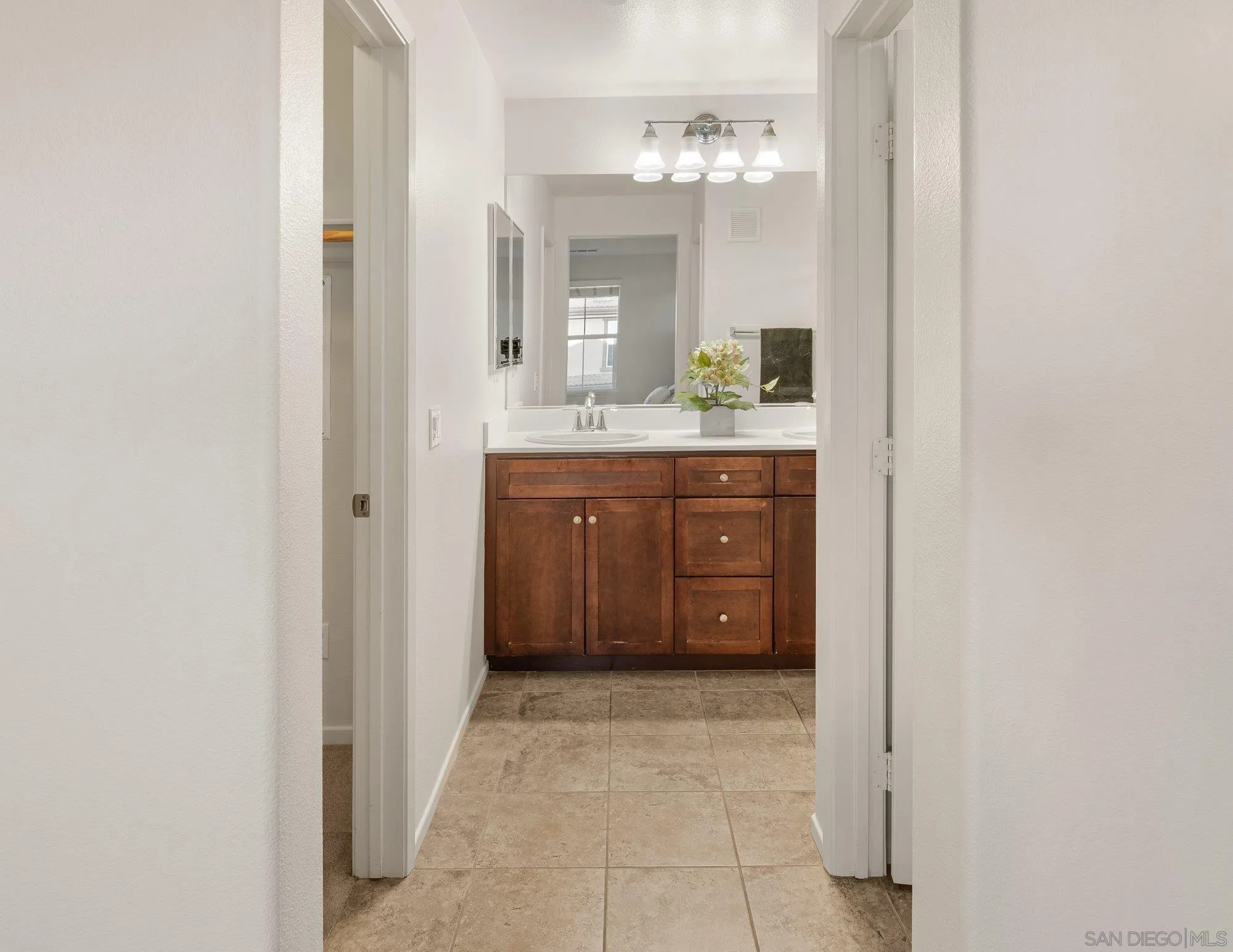 1402 Calabria Street Santee, CA 92071 - Photo 20 of 40 a bathroom with a granite countertop sink a mirror and a