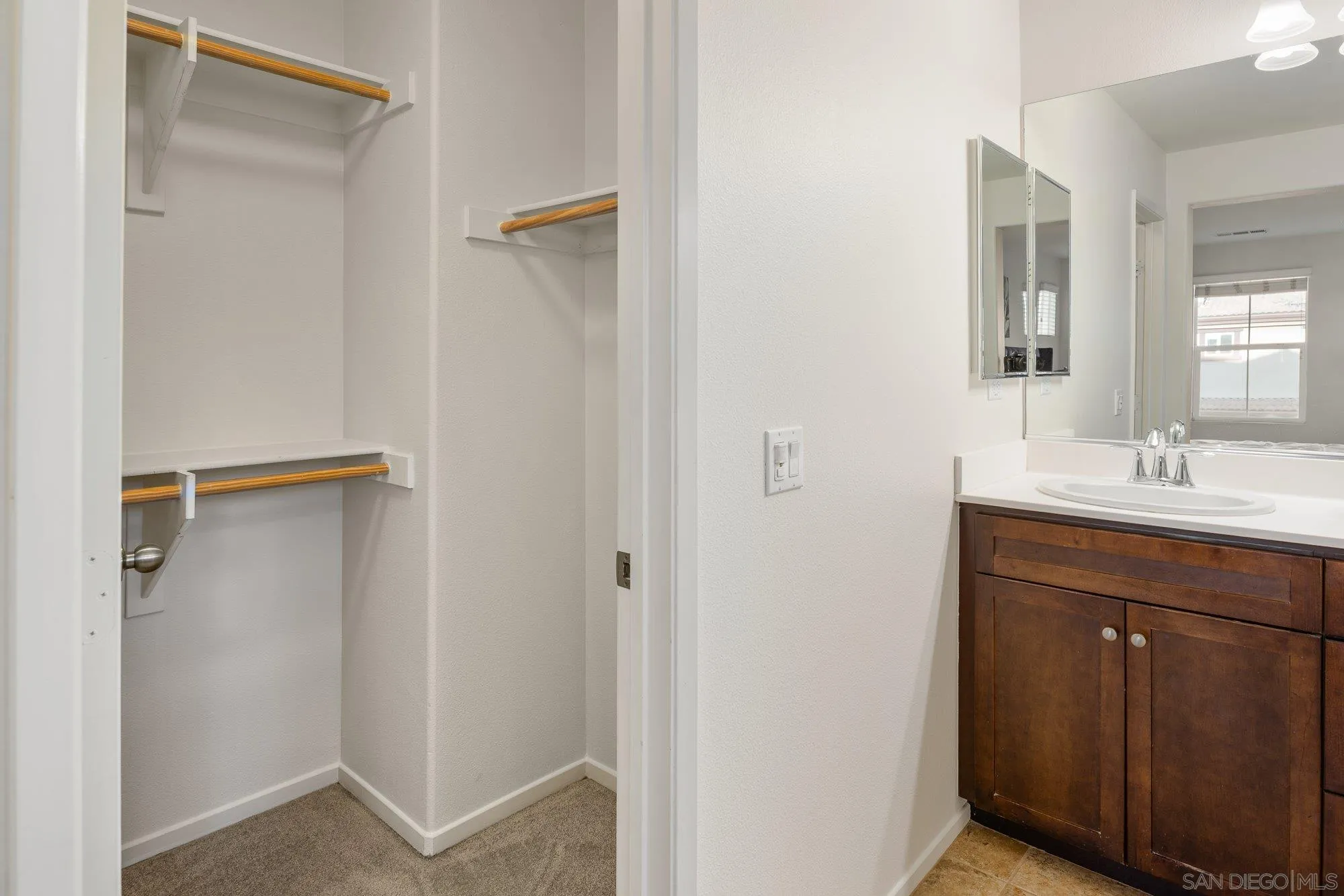 1402 Calabria Street Santee, CA 92071 - Photo 21 of 40 a bathroom with a shower sink and mirror