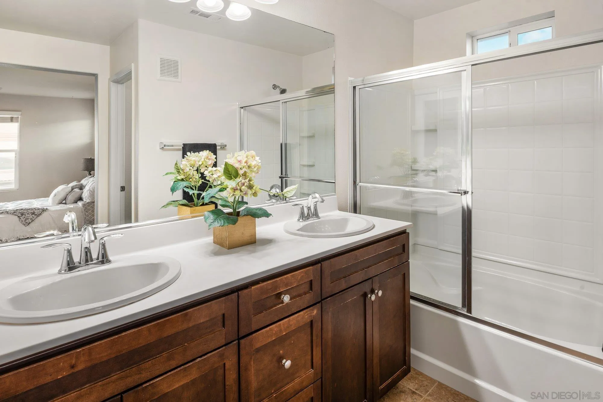 1402 Calabria Street Santee, CA 92071 - Photo 22 of 40 a bathroom with a granite countertop sink a mirror and a shower