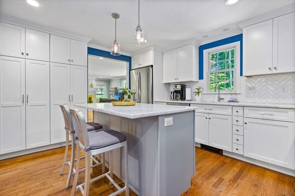 1 Harvest Lane Hingham, MA 02043 - Photo 17 of 42 a kitchen with stainless steel appliances granite countertop a stove a sink refrigerator and white cabinets with wooden floors